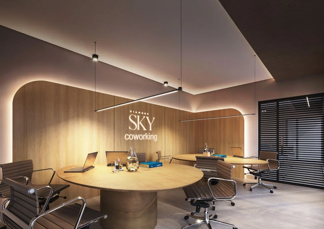 Sky Coworking, com mesas redondas e iluminação em linhas de luz